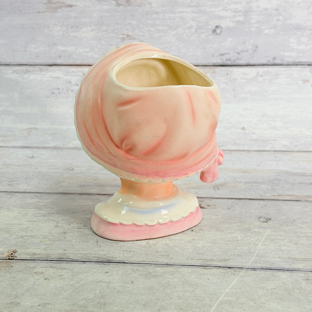 Rear view of pink bonnet and white collar