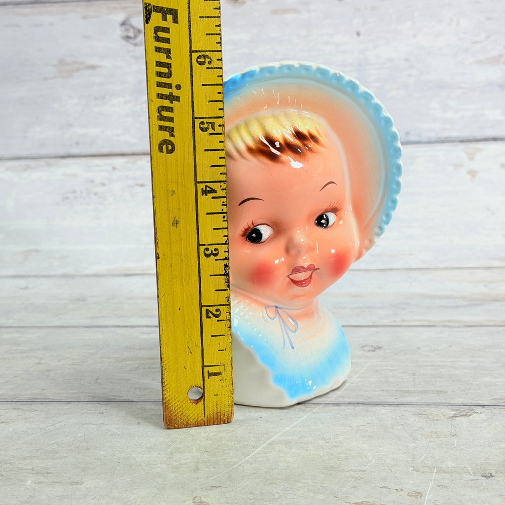 Blue bonnet vase beside height ruler