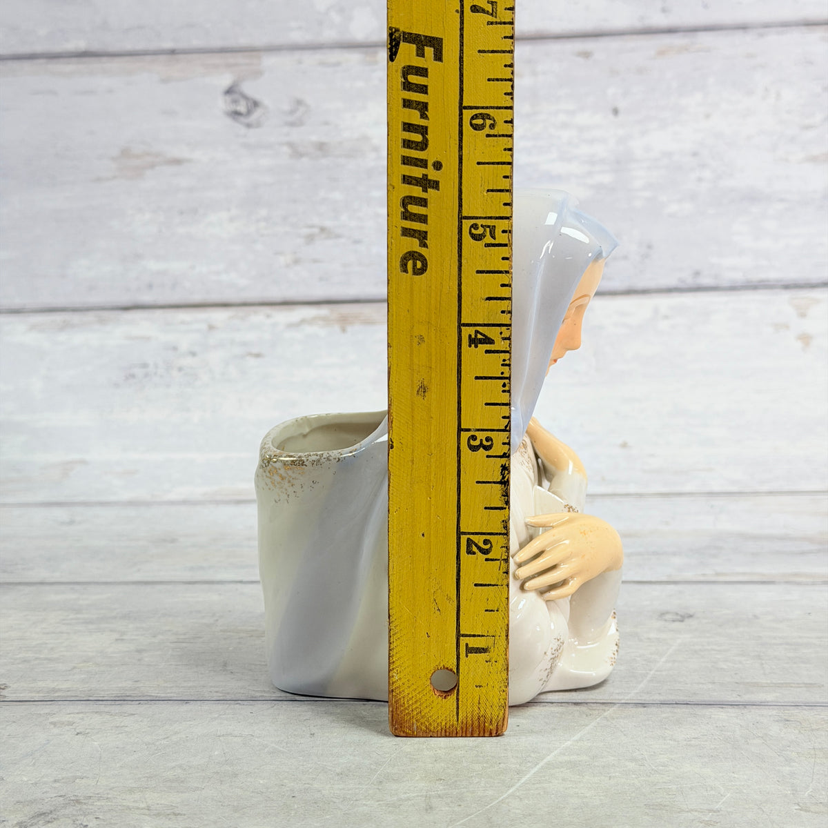 Mary planter beside height ruler
