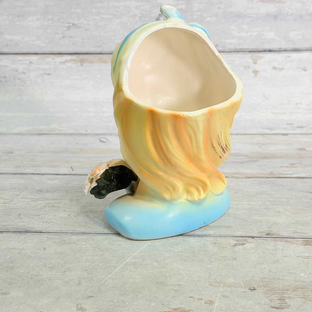 Rear showing blonde hair and vase interior