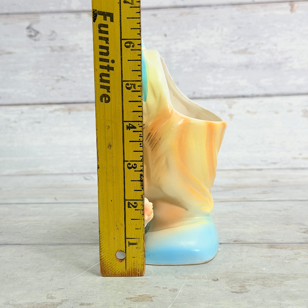 Girl vase beside height ruler