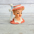 Front of Napco coral hat vase with white ribbon