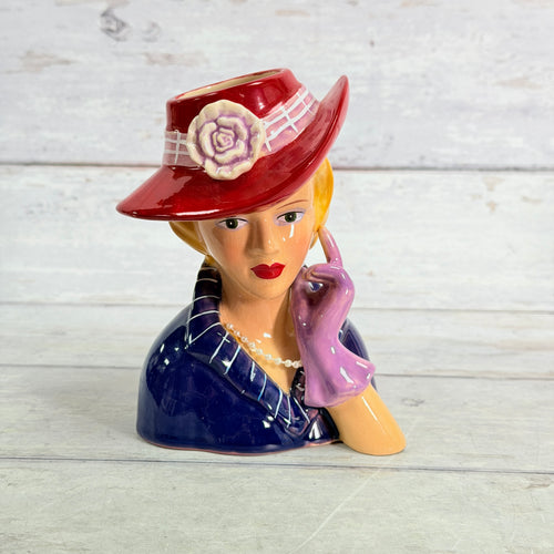 Front of A Special Place red hat vase with purple glove