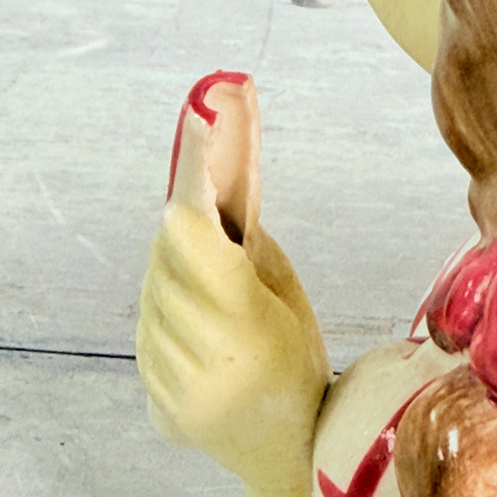 Close view of chipped cylinder beside hand