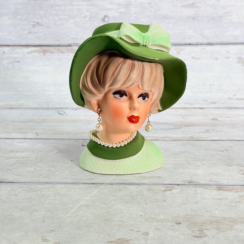 Front of Napcoware green hat vase with pearl-style jewelry