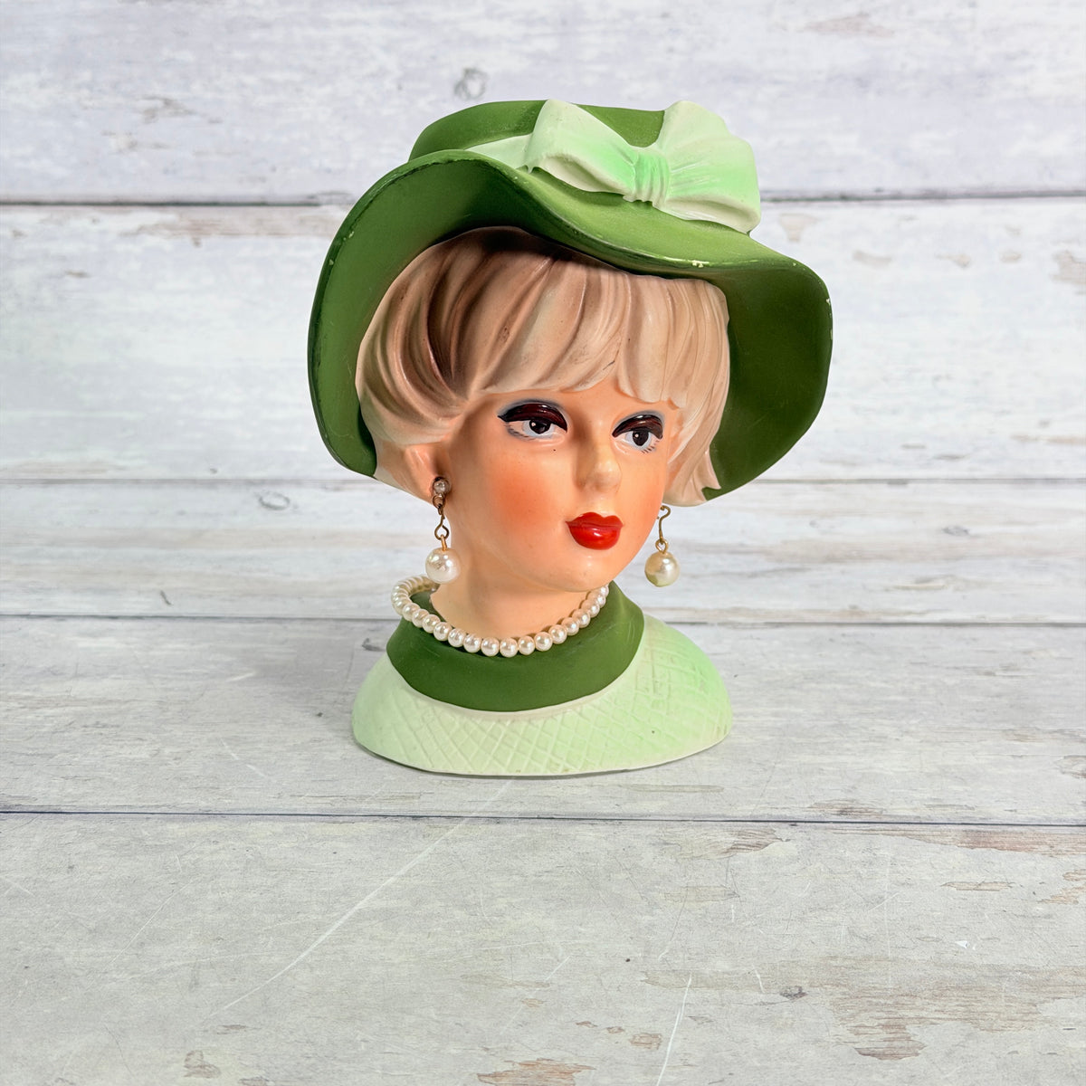 Front of Napcoware green hat vase with pearl-style jewelry