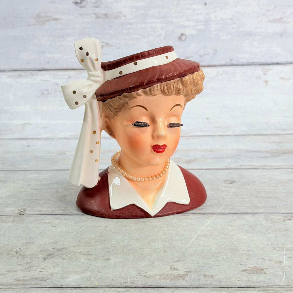 Front of Napco burgundy hat vase with long white ribbon