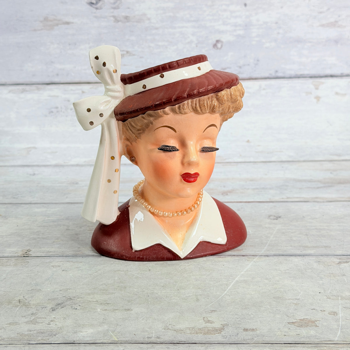 Front of Napco burgundy hat vase with long white ribbon
