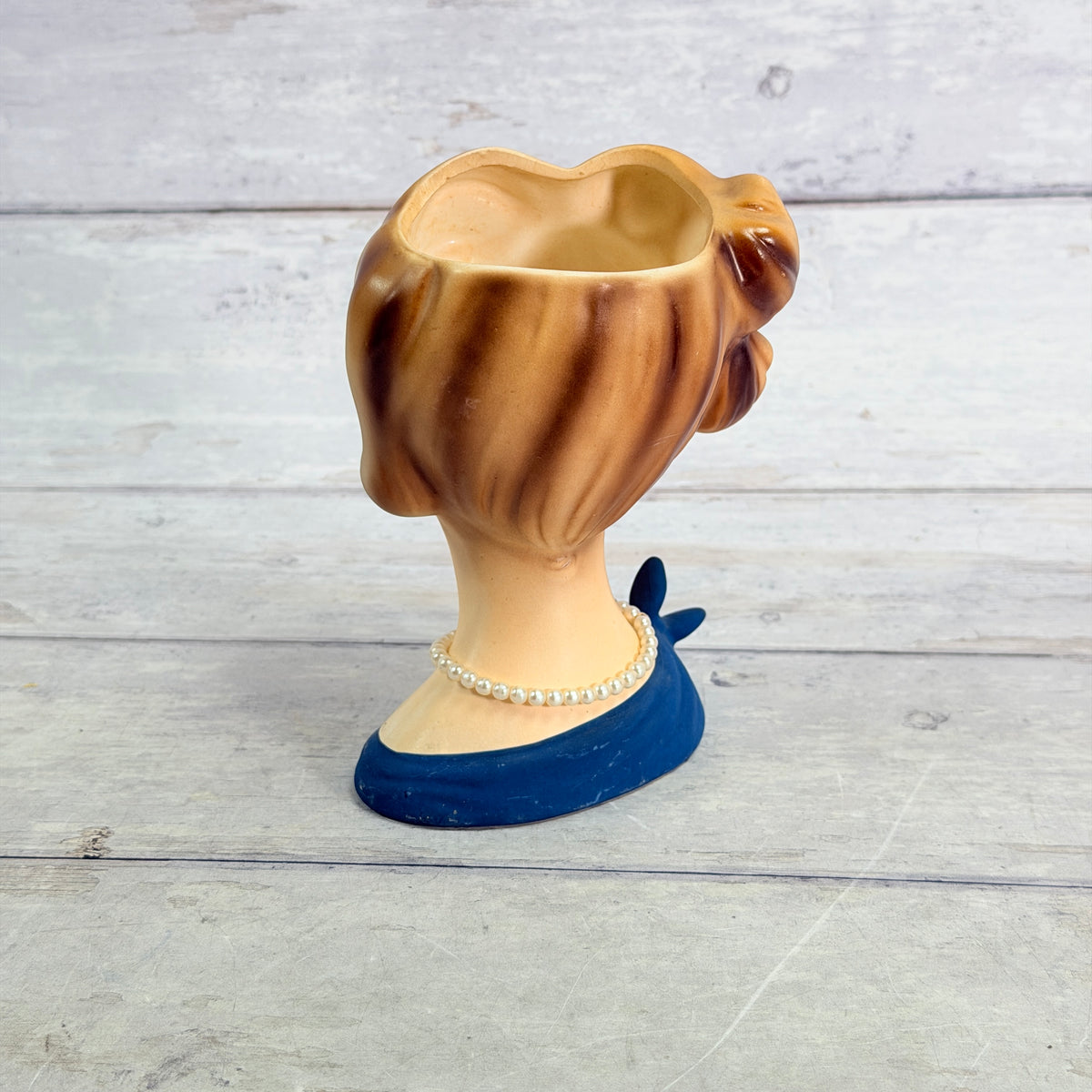 Rear showing updo and pearl-style necklace