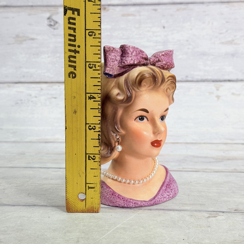 LH34 — Purple bow vase beside ruler
