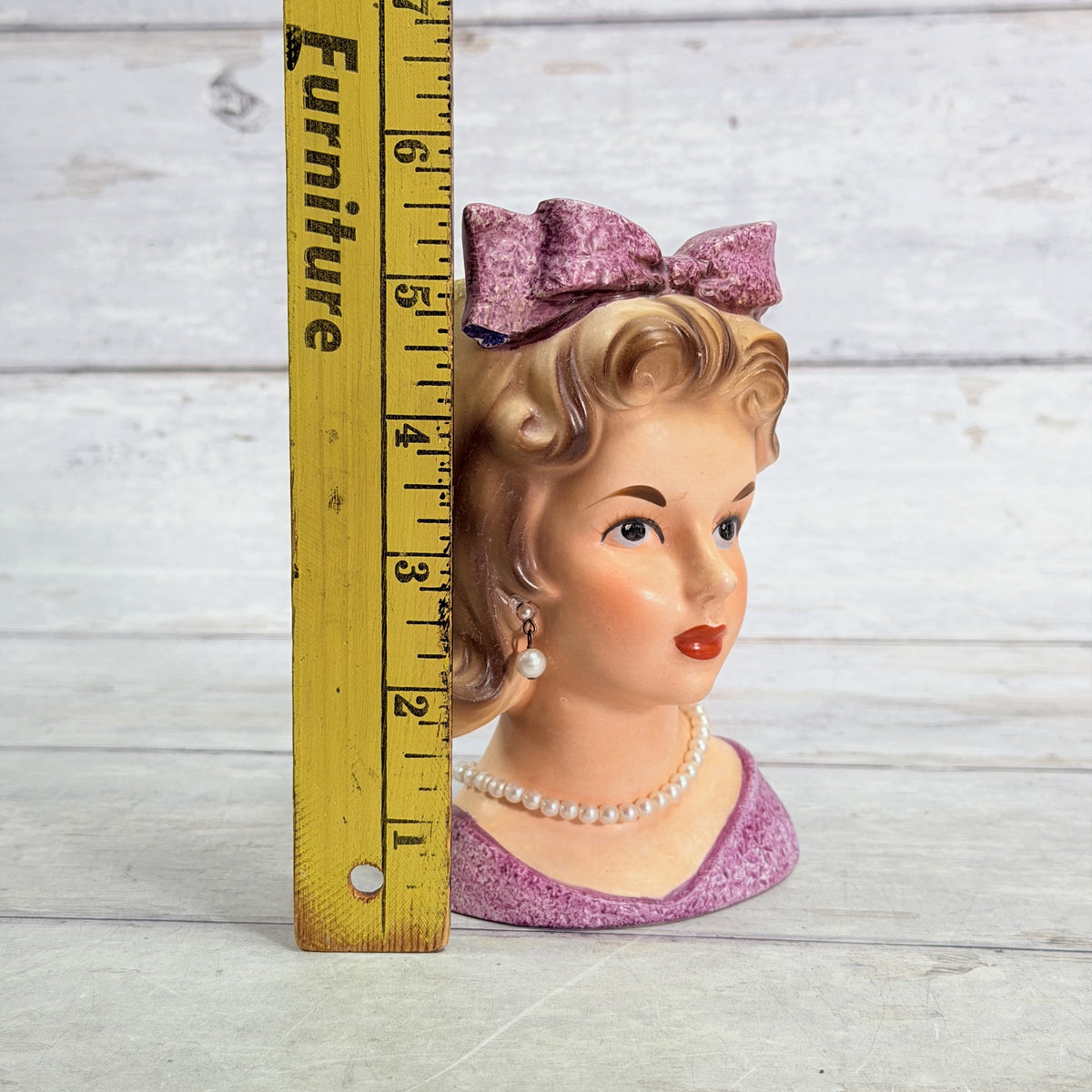 LH34 — Purple bow vase beside ruler