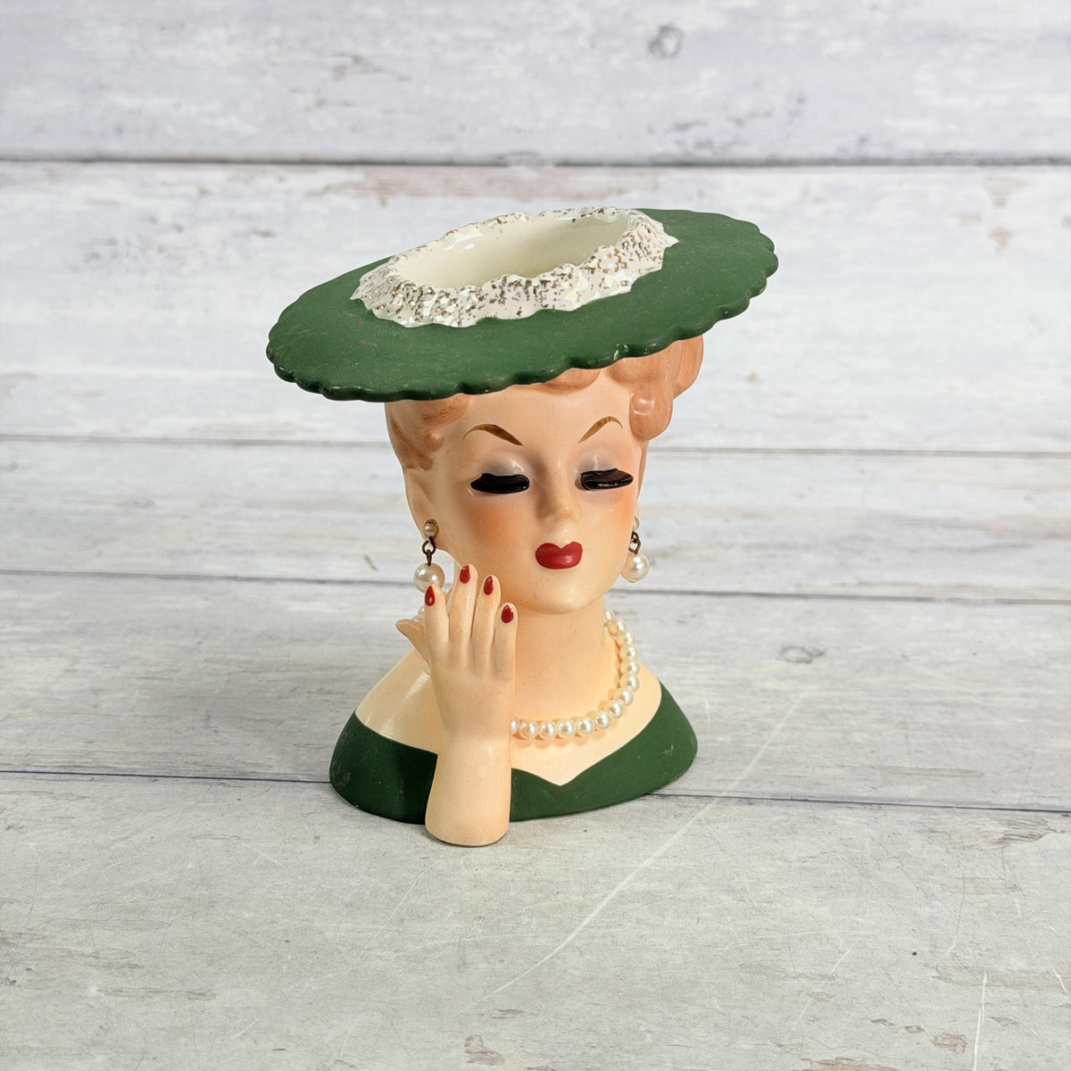 LH35 — Front of Napco green hat vase with hand at cheek