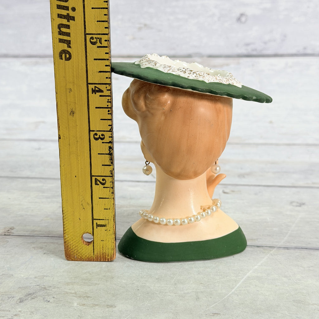 LH35 — Green hat vase beside ruler