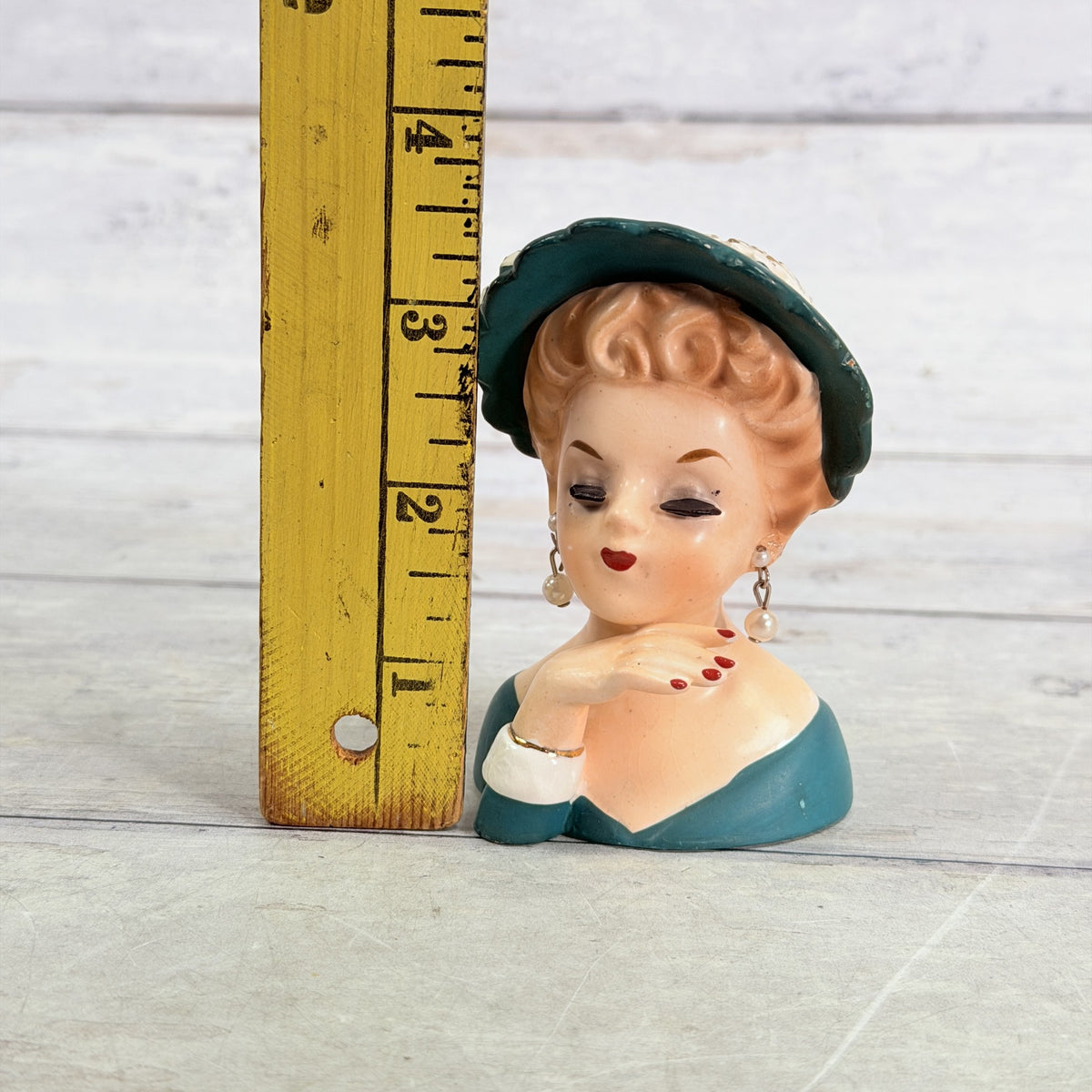 LH36 — Teal hat vase beside ruler