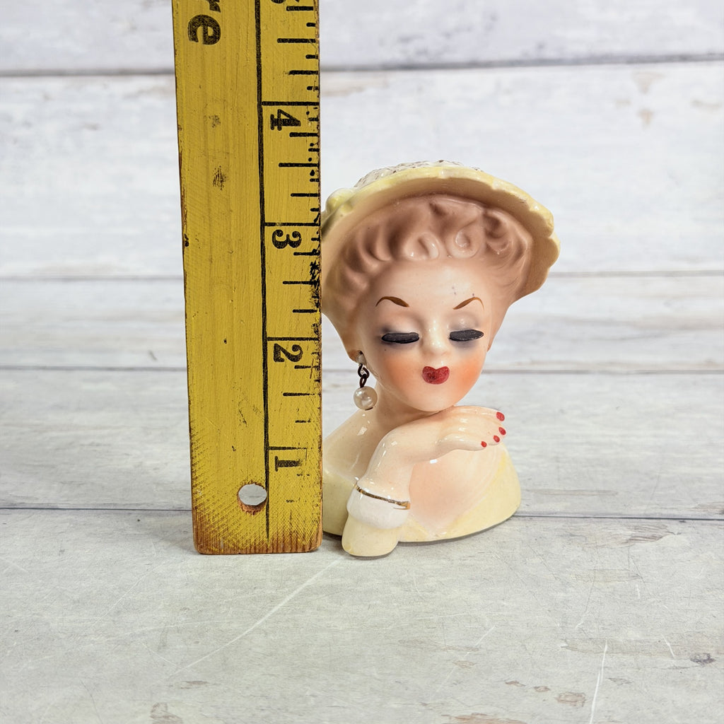 LH46 — Yellow hat vase beside ruler