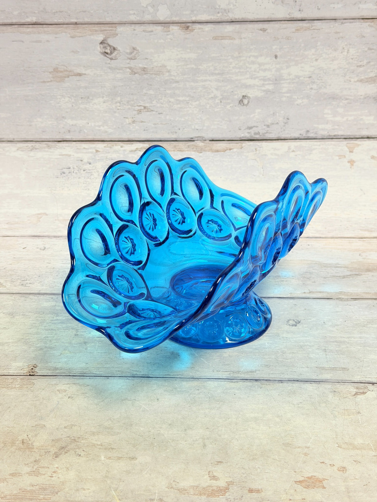 Colonial blue Moon and Star pressed glass banana bowl on pedestal, angled front view