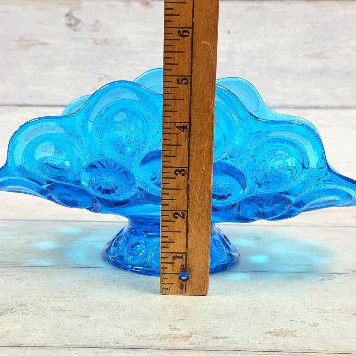 Colonial blue Moon and Star banana bowl with ruler showing approximately five inch height