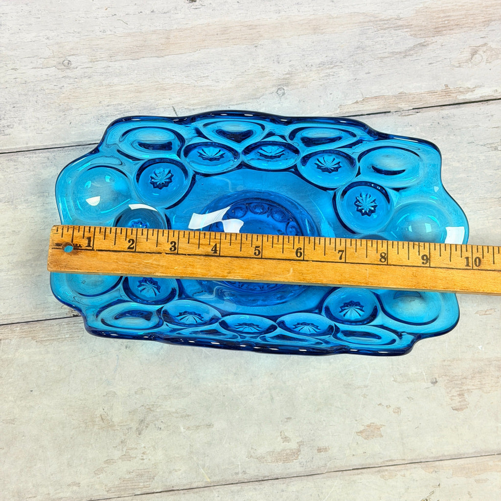 Overhead view of colonial blue Moon and Star banana bowl with ruler showing approximately ten inch length