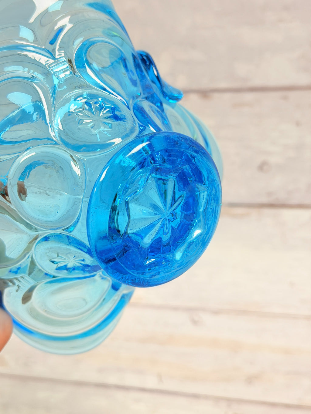 Starburst pattern on underside of Colonial Blue Moon and Star basket pedestal