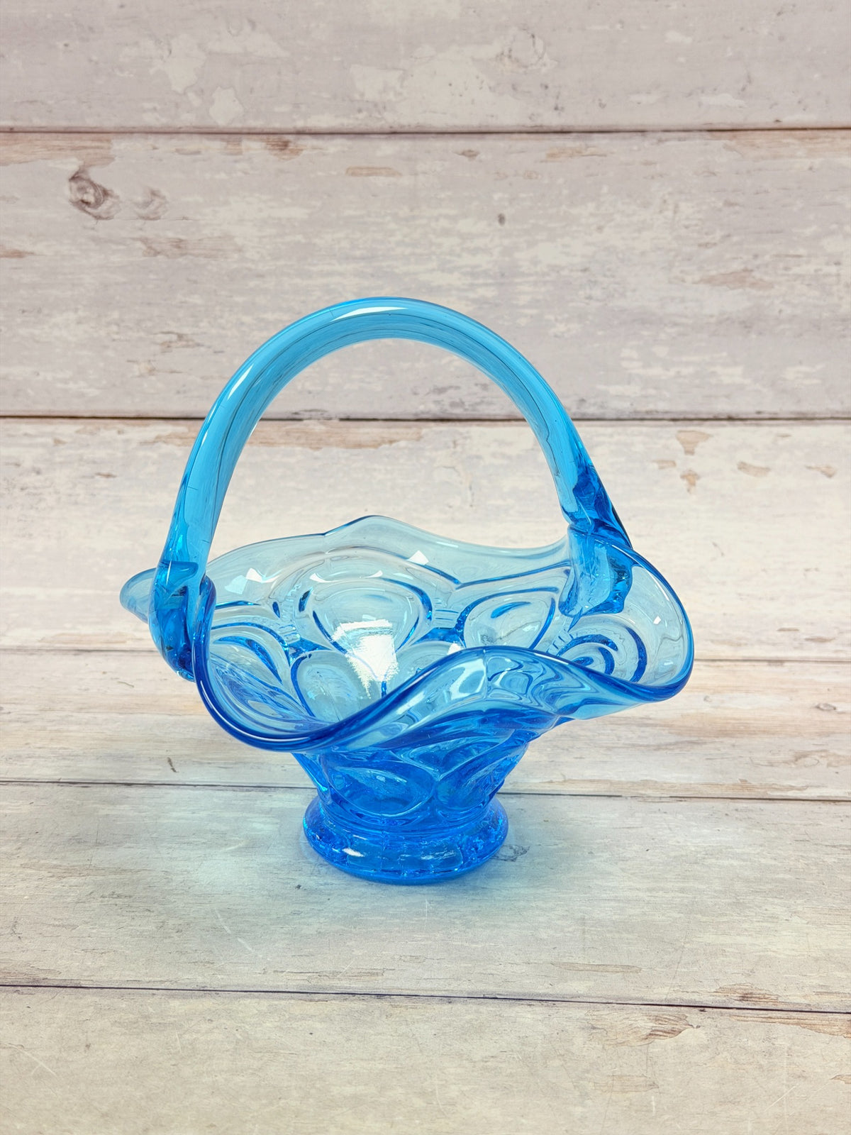 Front view of Colonial Blue Moon and Star footed glass basket with arched handle