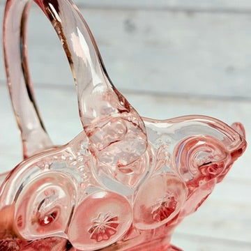 One applied handle attachment on pink glass basket
