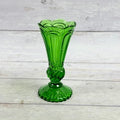 Emerald green pressed glass pedestal bud vase with scalloped rim and ornate stem
