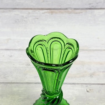 Scalloped rim and recessed panels on emerald green glass bud vase