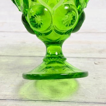 Decorative stem and foot of green glass compote