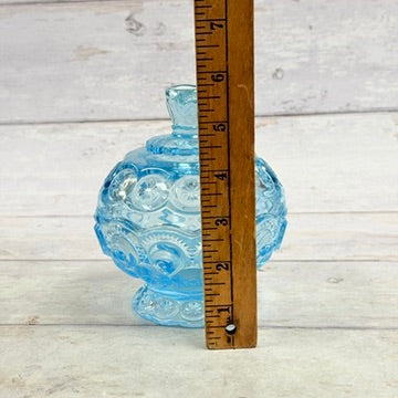 Moon and Star light blue candy dish beside height ruler
