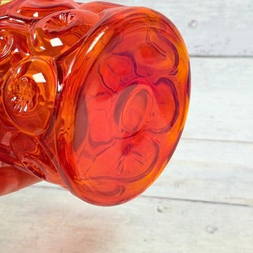 Underside of amberina pressed glass canister