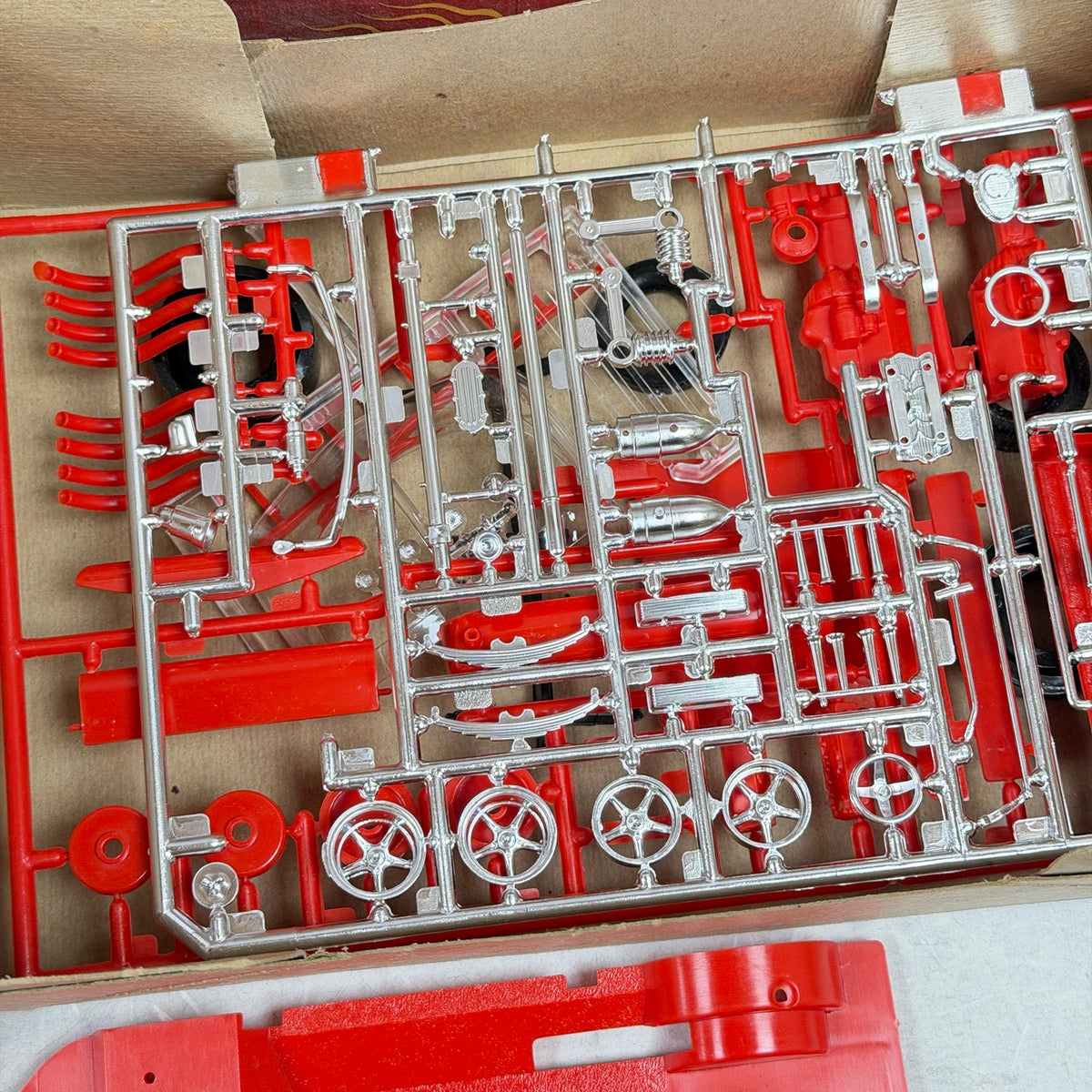 Red and chrome-plated Firebomb model kit parts on sprues