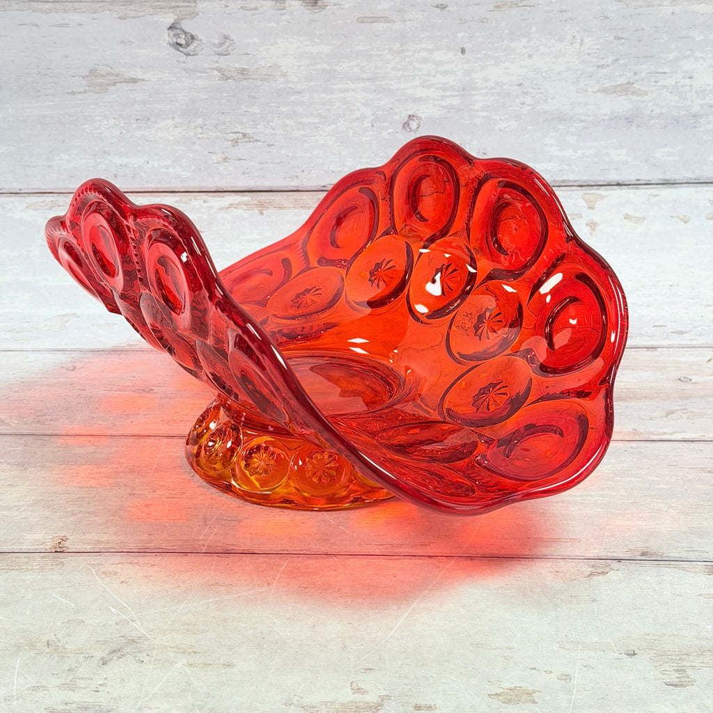 Angled view of the Moon and Star amberina glass pedestal banana bowl