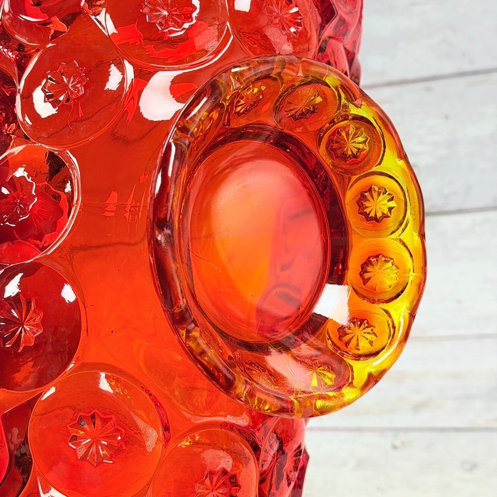 Underside of the amberina bowl showing the pedestal base and surface marks