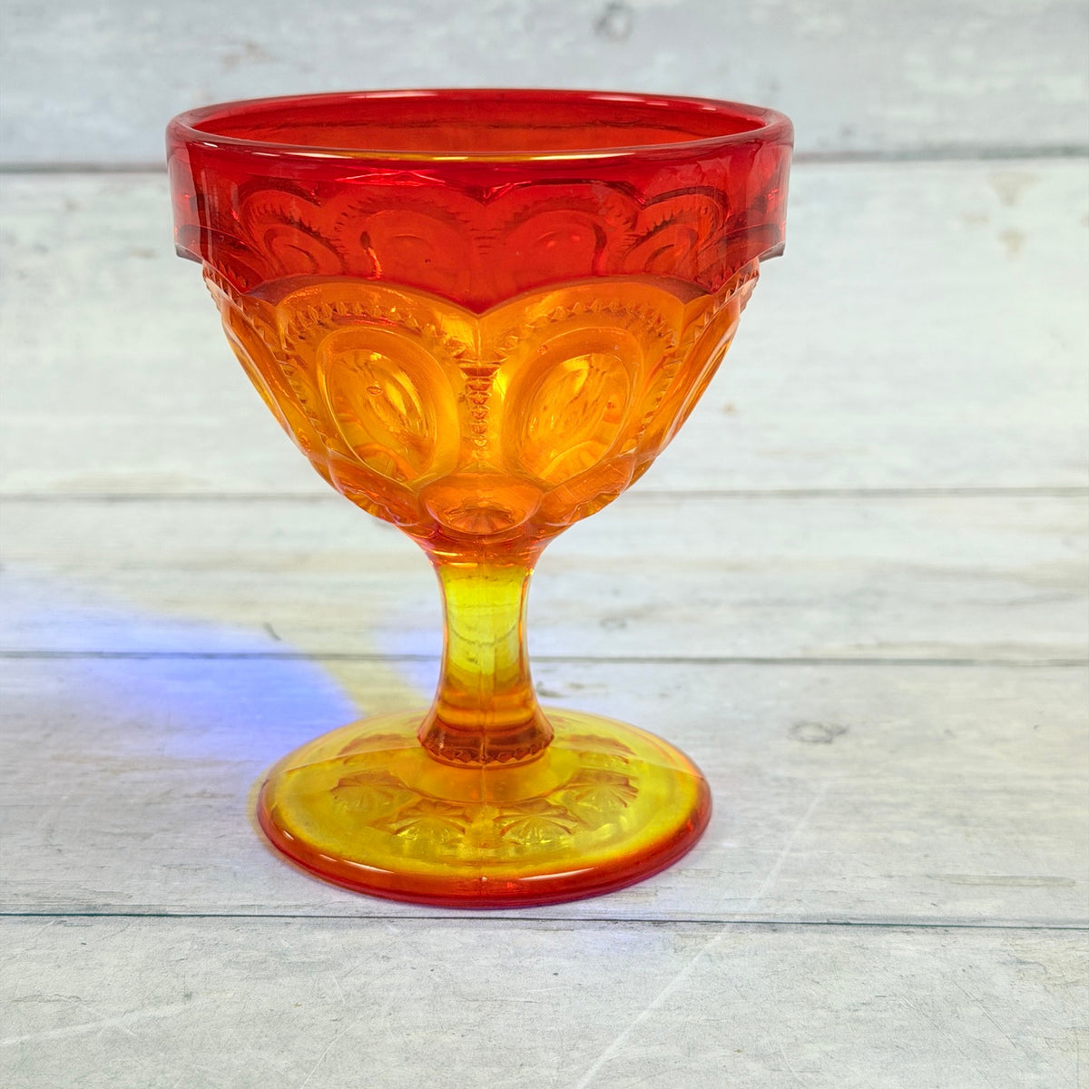 Close-up of amberina Moon and Star sherbet cup under accent lighting