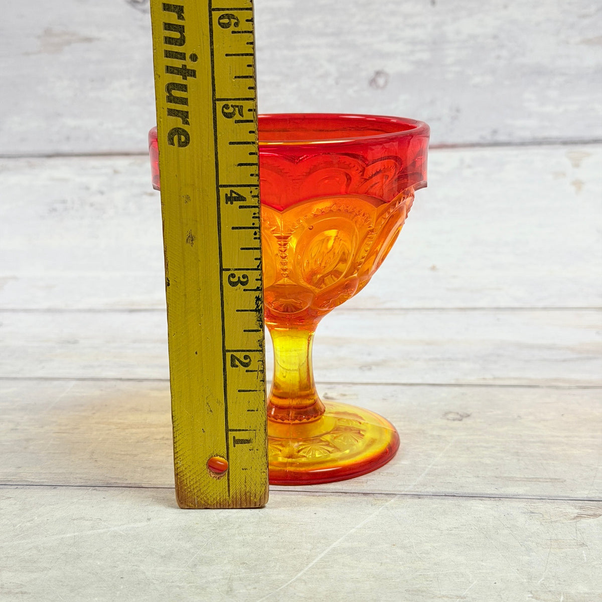 Moon and Star amberina sherbet cup beside ruler showing approximate five-inch height