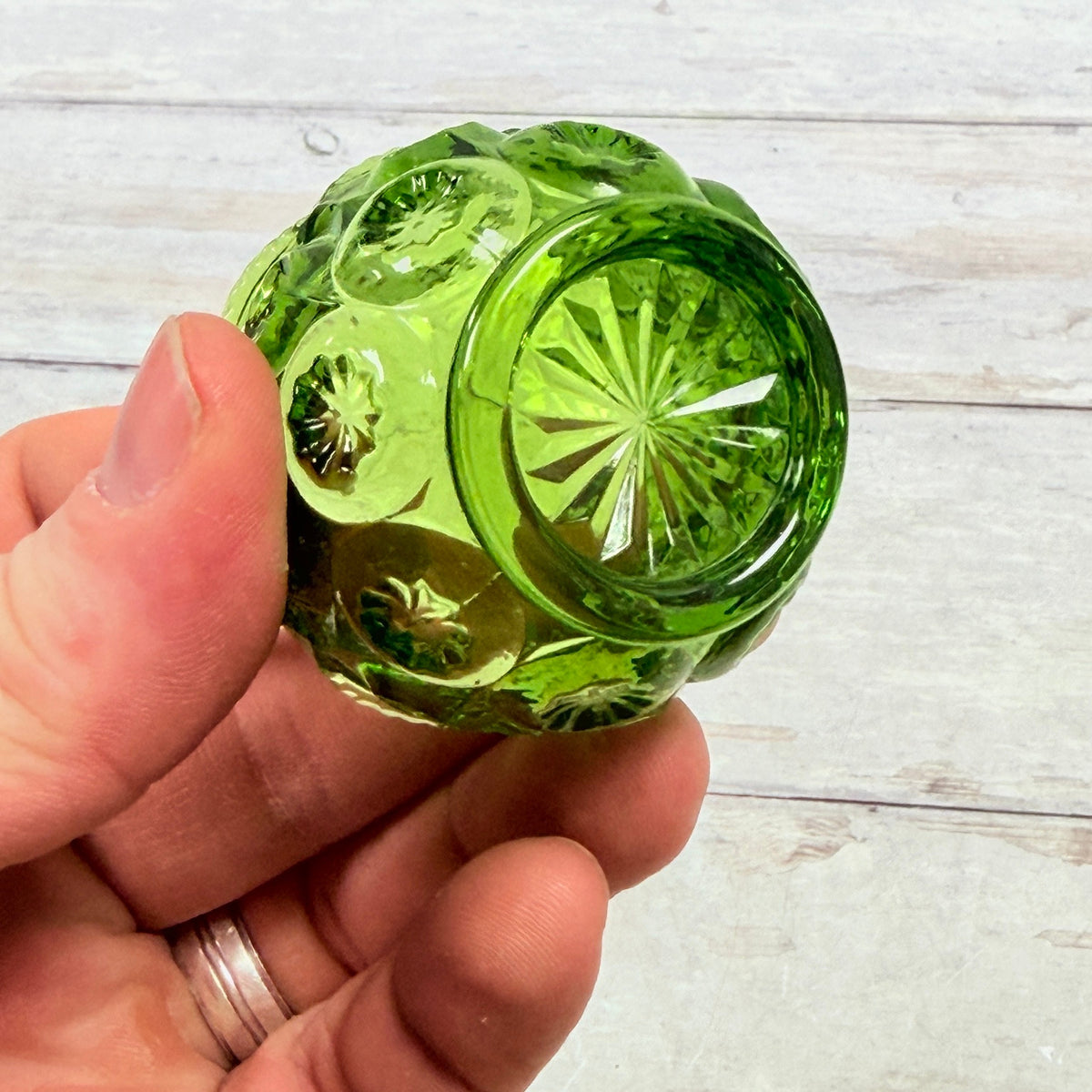Underside of green glass Moon and Star salt dip showing ring foot and starburst
