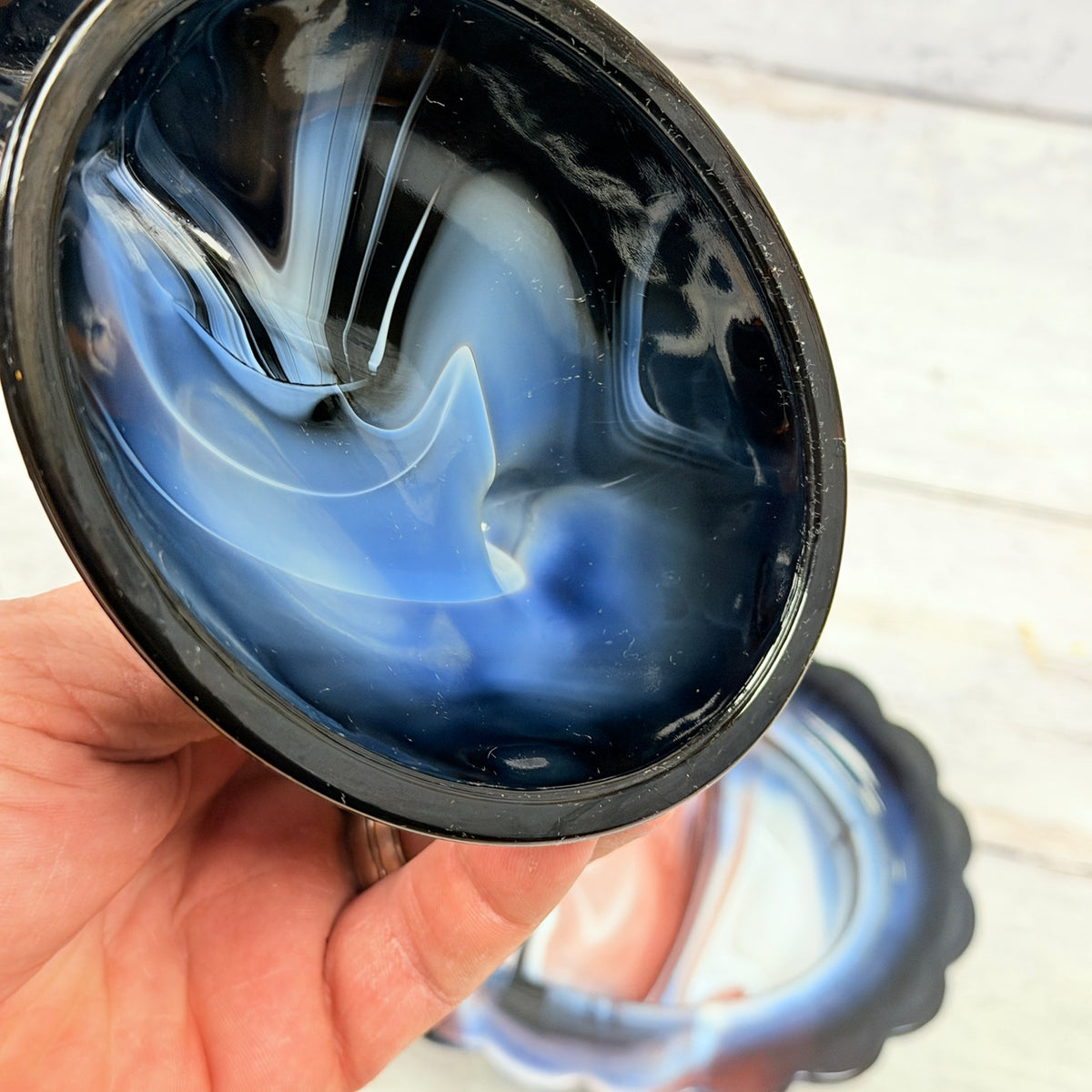 Close-up of the maker mark on the Mosser Glass amethyst and white slag hen lid