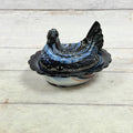 Side view of Mosser Glass amethyst and white slag glass hen-on-nest dish