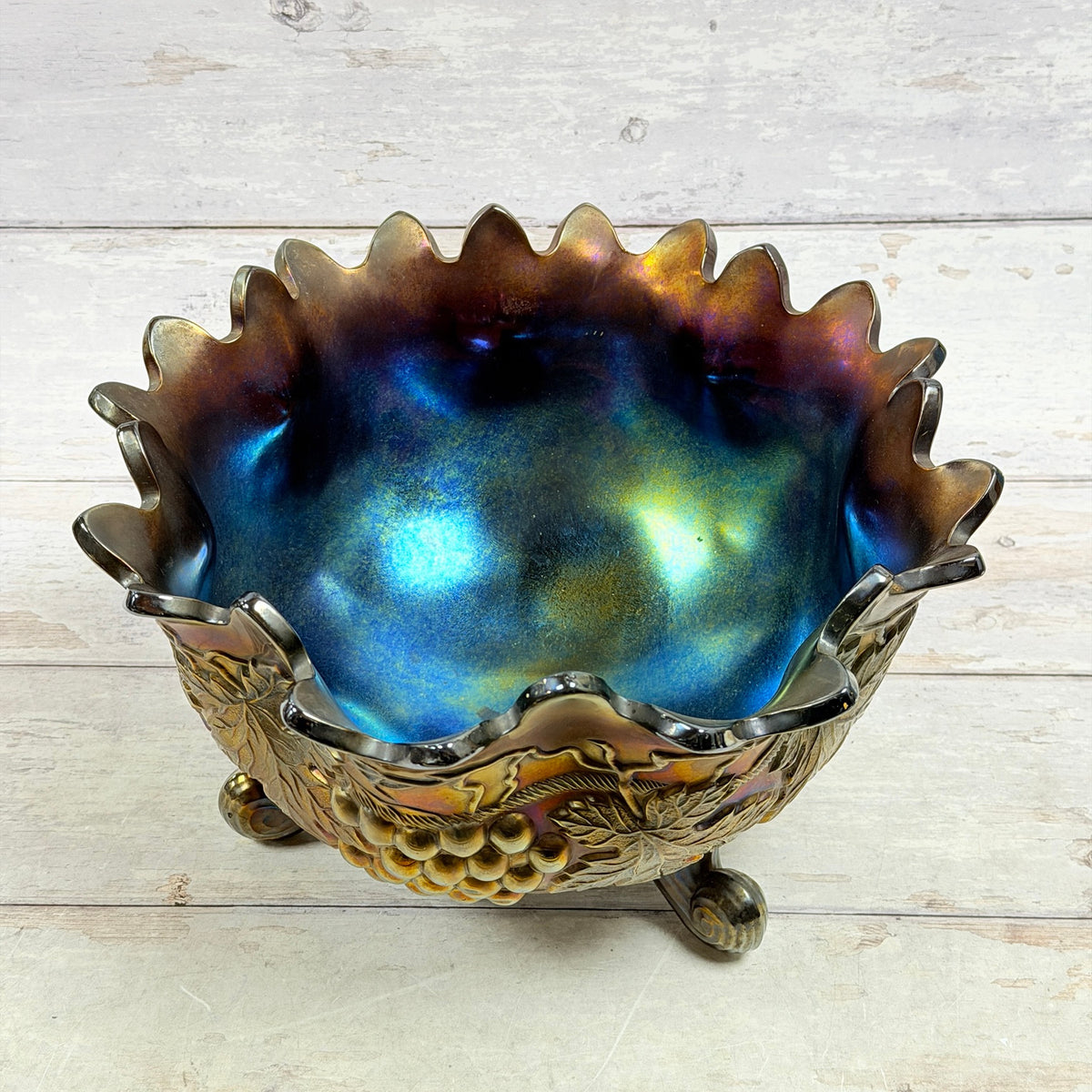 Plain interior of Northwood carnival glass fruit bowl showing blue teal purple and gold iridescence
