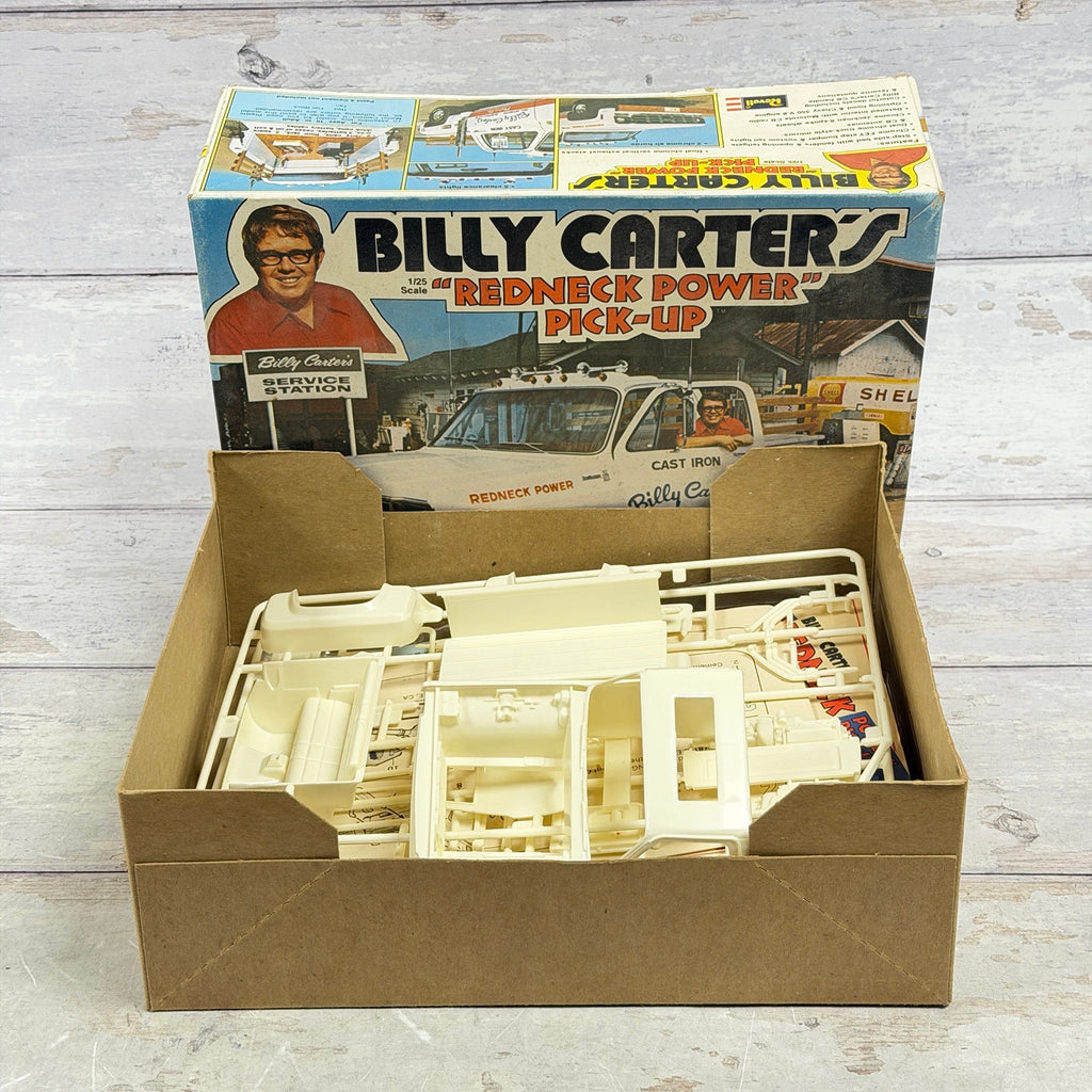 Open box of Revell H-1385 Billy Carter's pickup kit with cream plastic parts and printed instructions