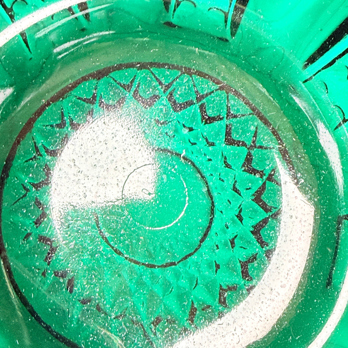 Close-up of the Greenbriar bowl interior base showing molded starburst detail, small surface specks and light marks