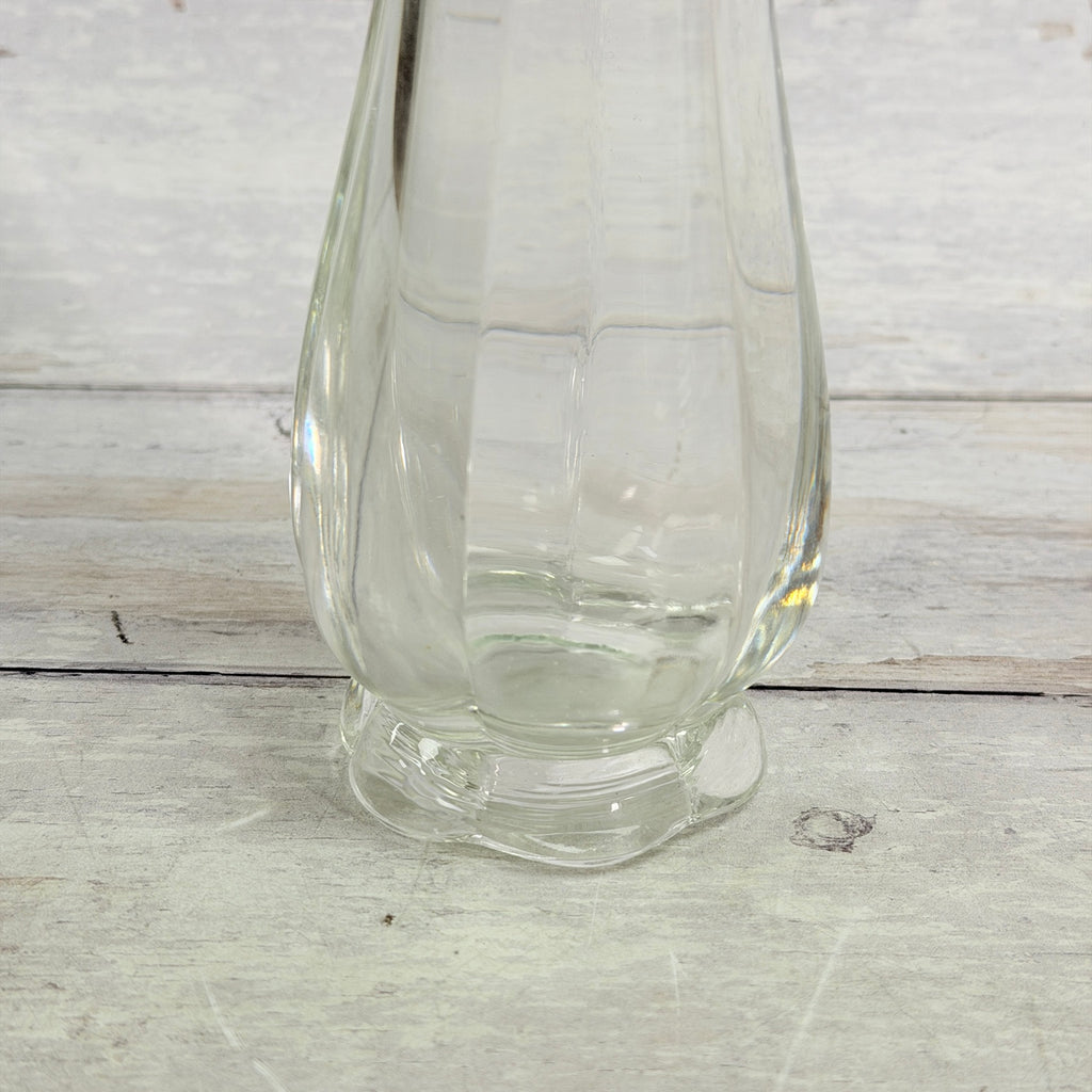 Close-up of the footed base and lower body of the clear swung vase