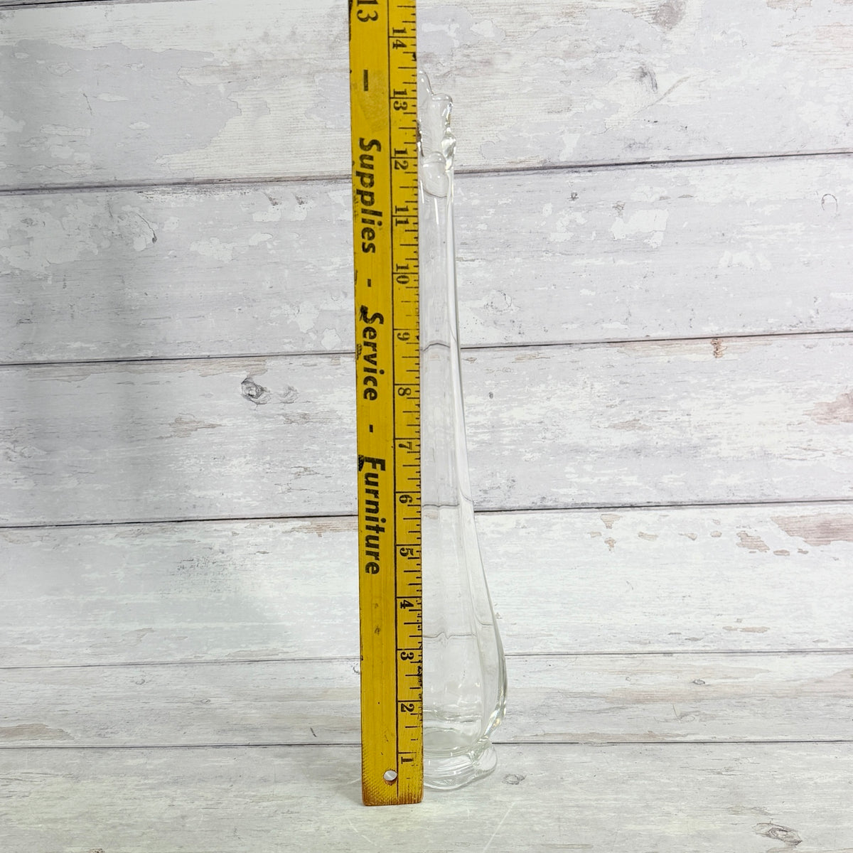 Clear swung vase shown beside a ruler, approximately 13 inches tall