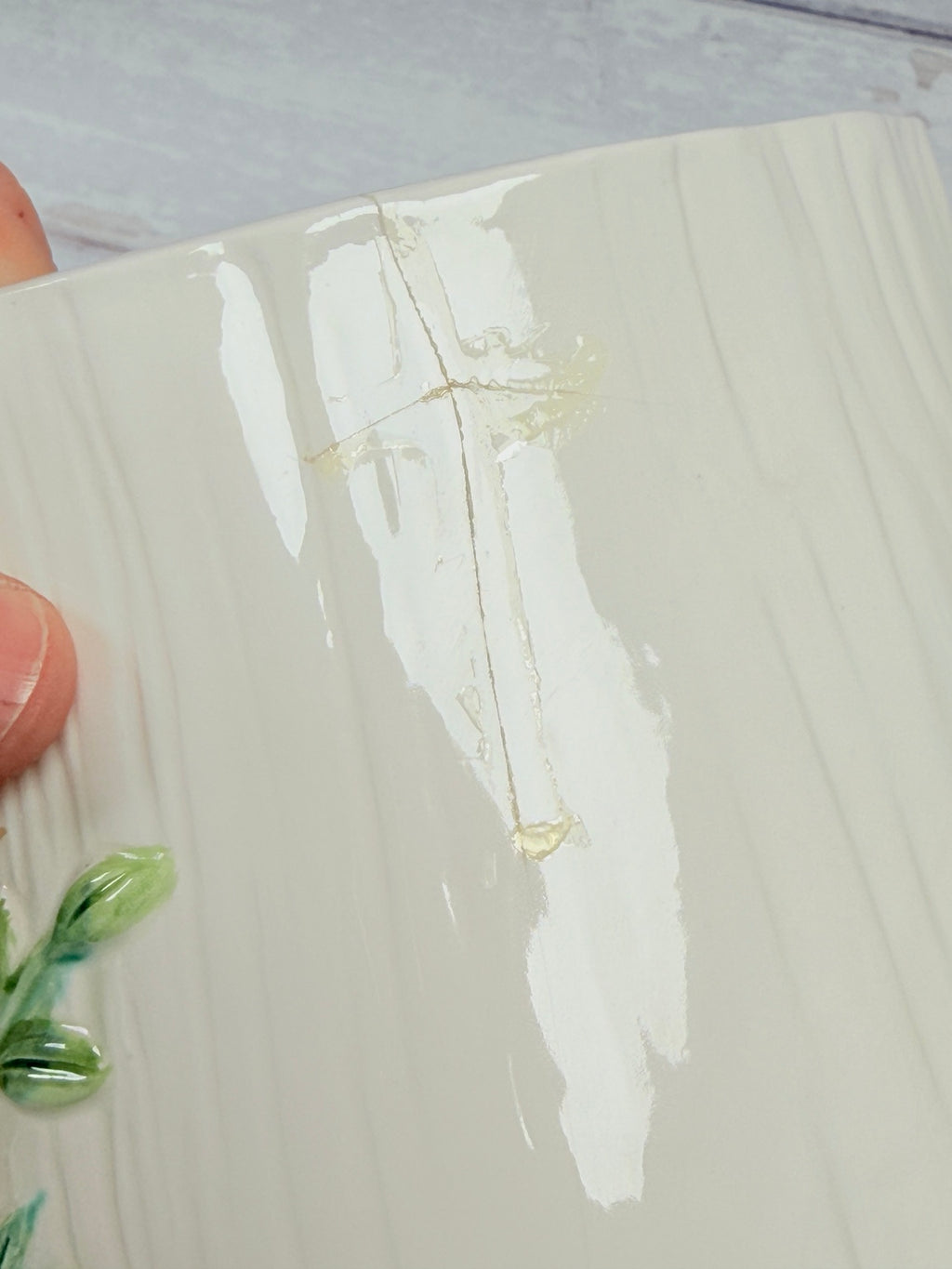 Close-up of repaired crack on side of ceramic mushroom canister
