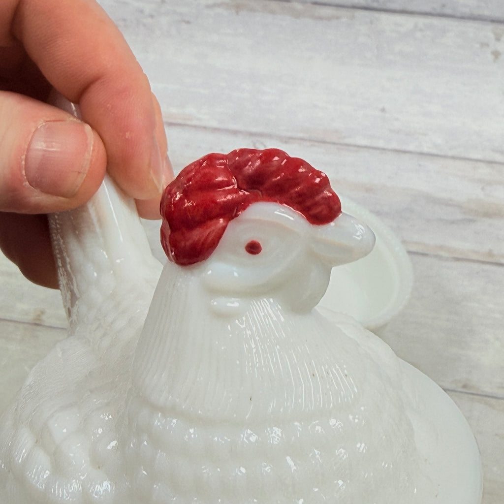 Close-up of the hen's painted red comb and face