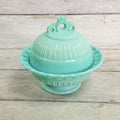 Fostoria Randolph aqua blue milk glass covered candy dish, front view showing pierced lace rim, ribbed dome lid and pedestal base.