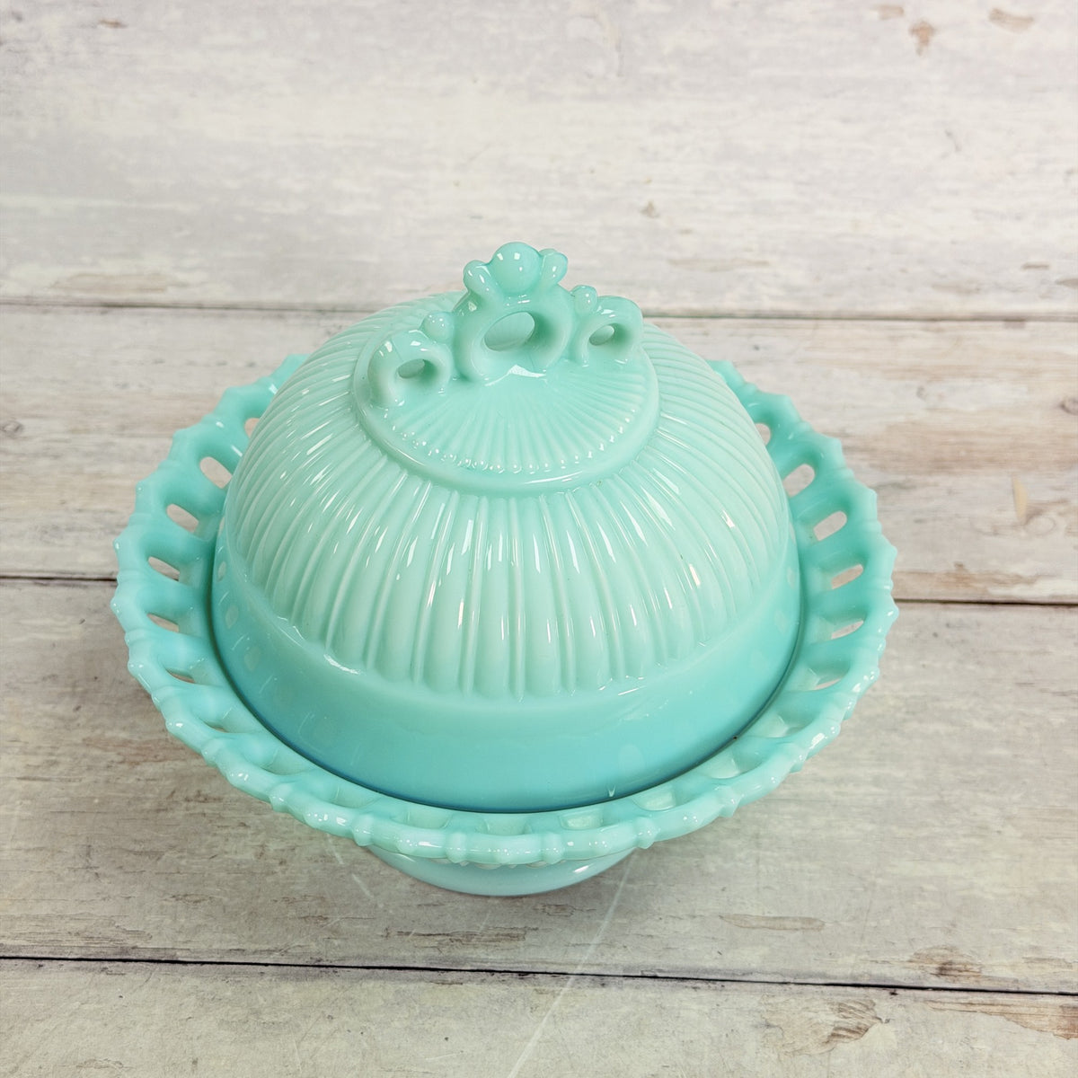 Top view of Fostoria Randolph aqua blue milk glass candy dish showing ribbed lid and pierced finial.