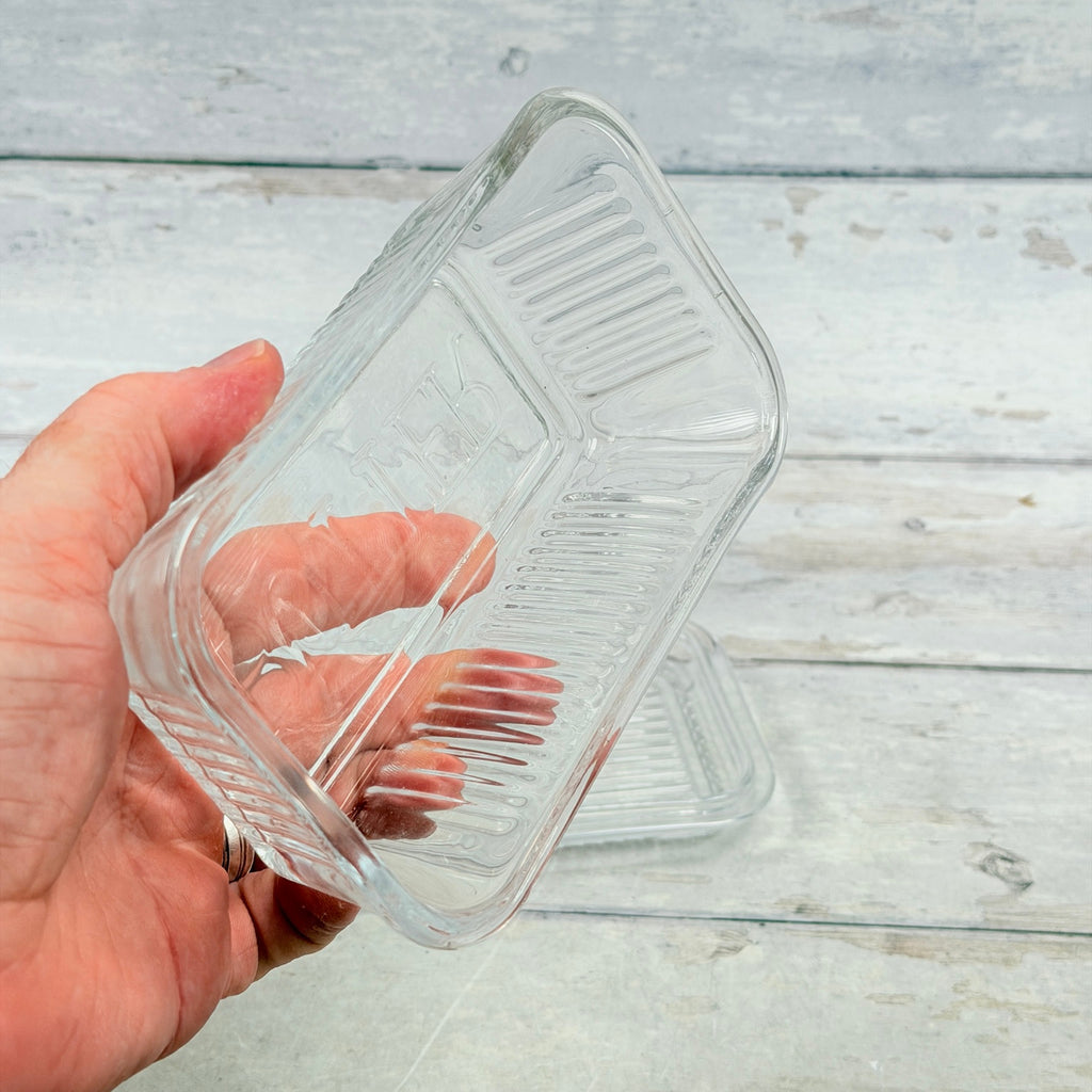 Inside view of clear glass butter dish lid showing vertical ribs and rim
