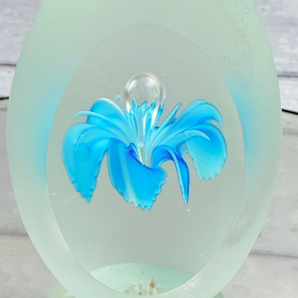 Close view of encased blue flower and central air bubble