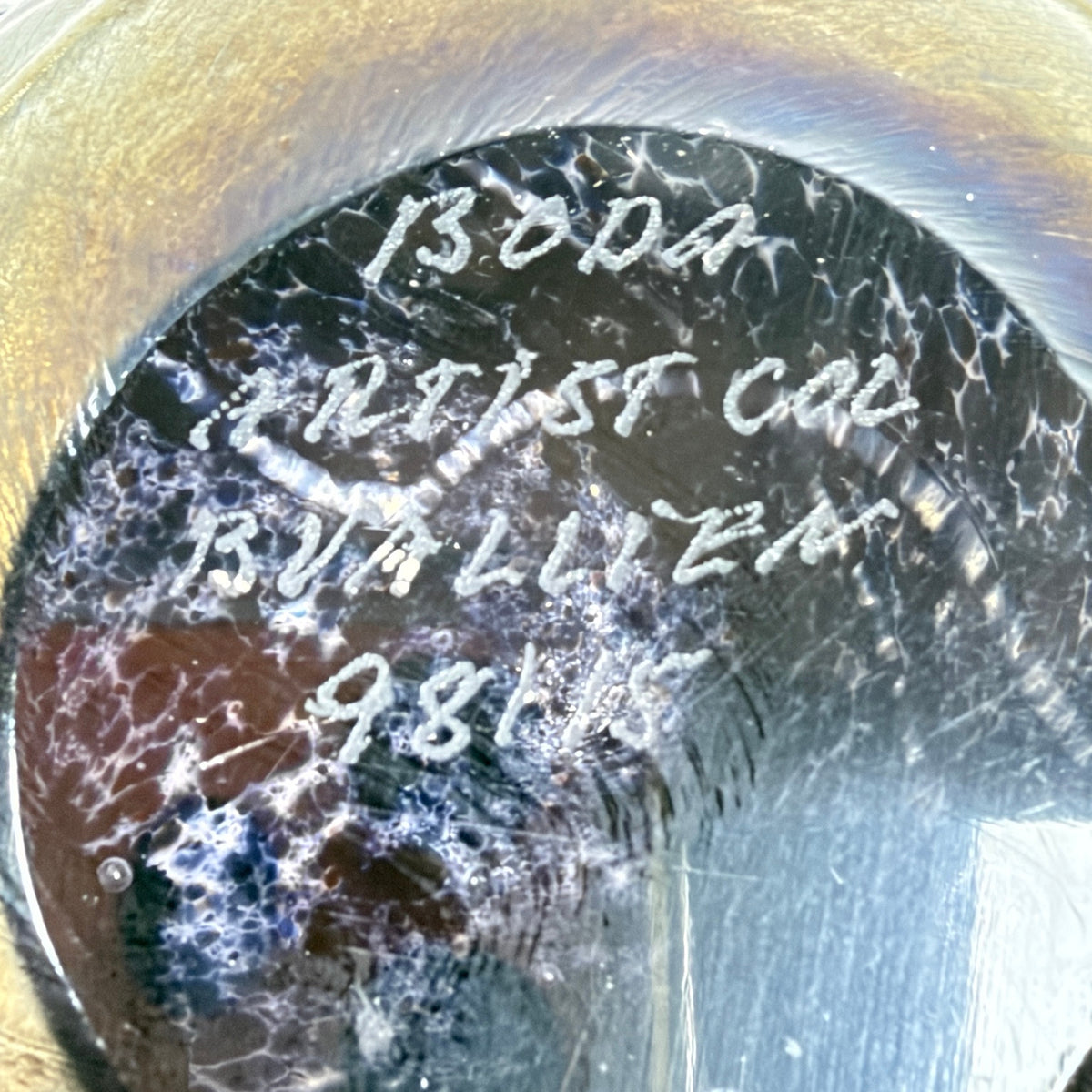 Close-up of etched Boda Artist Collection B. Vallien signature and model number on paperweight base